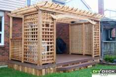Deck with privacy screens and a decorative pergola.