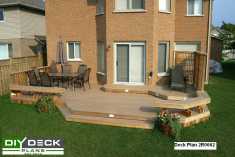 Large 2-level deck with benches and a privacy screen attached to a house.