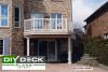 Completed second story deck with a white railing and trim.