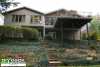 Large high single level deck attached to a house over a steeply sloped yard.