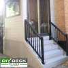 Small deck with a black aluminum railing attached to the side of a house.