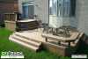 Large 2-level deck with an integrated wrap-around bench.