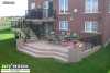 Large 2-level deck with black aluminum railing and step lights.