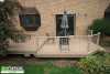 Medium size low 2-level composite deck with an aluminum railing.
