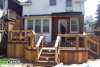 Medium size 2-level deck with a privacy screen.